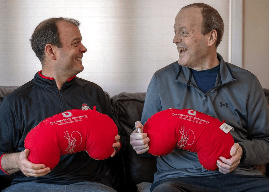 Mike and Steve Robinson holding matching kidney pillows